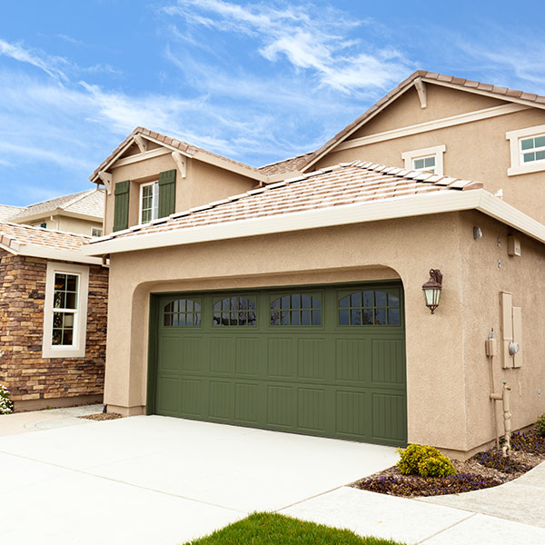 Stucco Home with dark green Garage doors in San Jose, CA