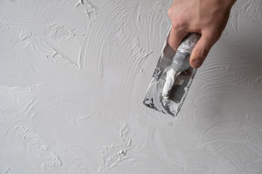 A person applying acrylic stucco, illustrating the process of using acrylic stucco in San Jose, CA