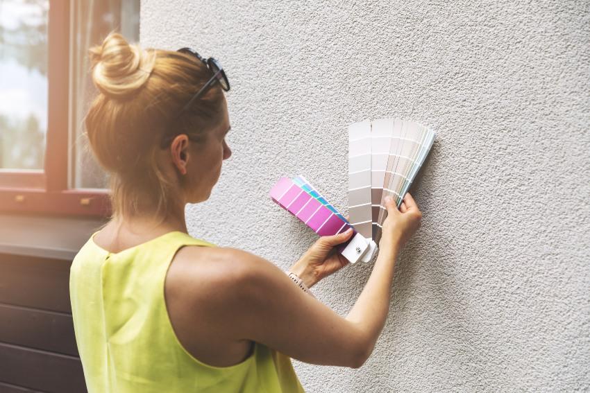 A woman examines a paint sample, evaluating color choices affected by the lighting in San Jose, CA
