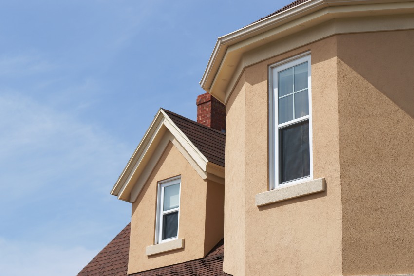 A house with a brown roof and white trim, showcasing stucco color maintenance in San Jose, CA.