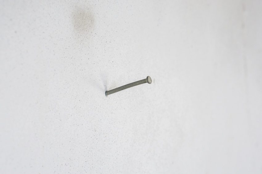 A protruding nail in a stucco wall located in San Jose, CA